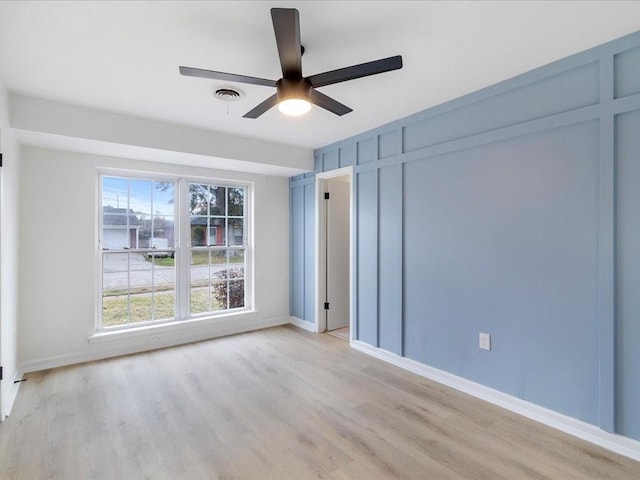 spare room featuring ceiling fan and light hardwood / wood-style flooring