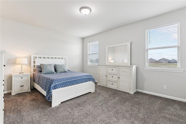 bedroom with dark colored carpet