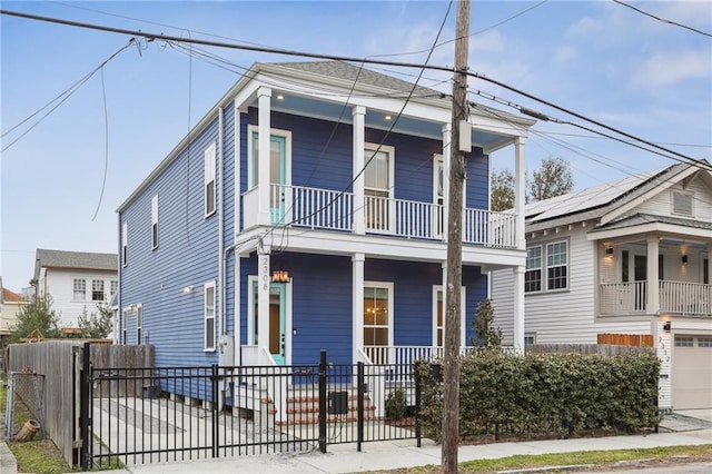 view of front of property featuring a balcony and covered porch