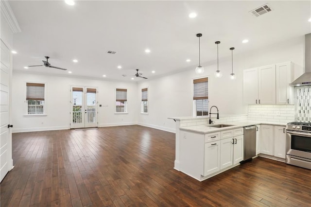 kitchen with white cabinetry, sink, kitchen peninsula, and appliances with stainless steel finishes