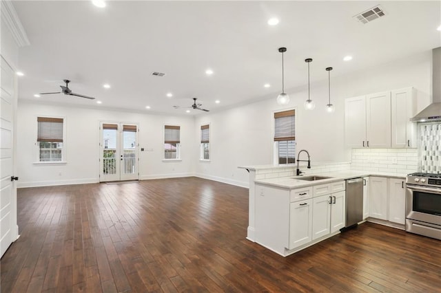 2308 Amelia St, New Orleans, LA 70115 - kitchen with a peninsula, ceiling fan, a sink, and stainless steel appliances