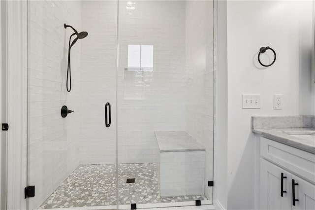 bathroom featuring vanity and a shower with shower door