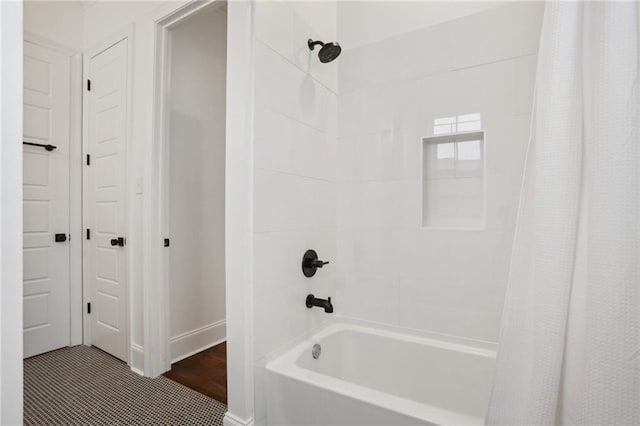 bathroom with shower / bath combination with curtain