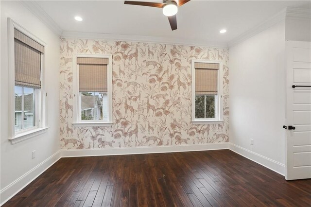 spare room with crown molding, ceiling fan, and dark hardwood / wood-style flooring