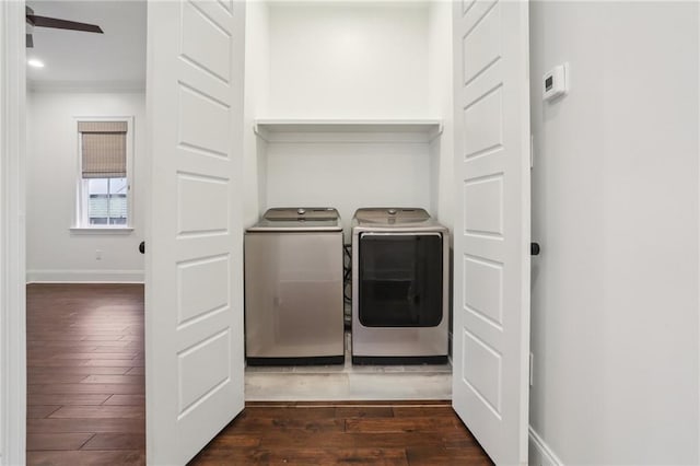 clothes washing area featuring dark hardwood / wood-style flooring, crown molding, and washer and clothes dryer