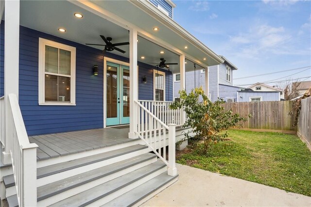 property entrance with a yard and ceiling fan