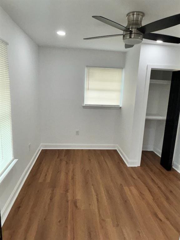 unfurnished room featuring dark hardwood / wood-style flooring and ceiling fan