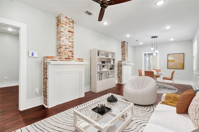 living area featuring visible vents, a ceiling fan, wood finished floors, a fireplace, and recessed lighting