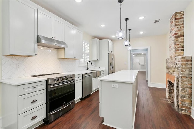 kitchen featuring dark wood finished floors, visible vents, backsplash, appliances with stainless steel finishes, and under cabinet range hood