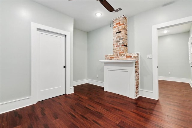 empty room featuring ceiling fan, wood finished floors, visible vents, and baseboards