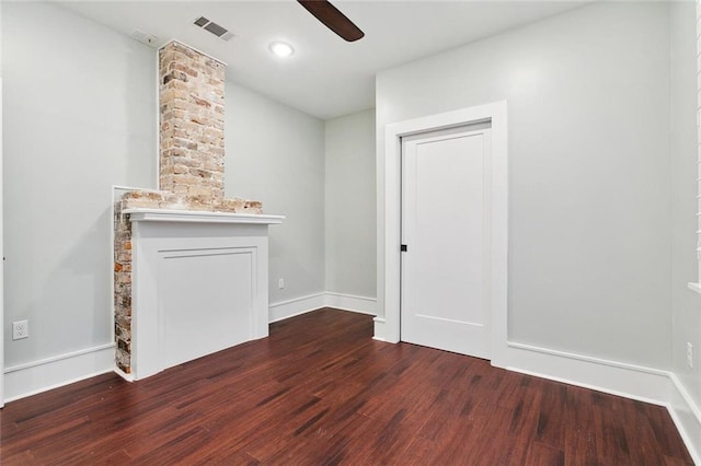 unfurnished living room with a fireplace, visible vents, ceiling fan, wood finished floors, and baseboards