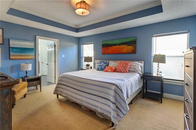 carpeted bedroom with crown molding, a raised ceiling, and a textured ceiling