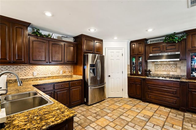 kitchen featuring dark brown cabinetry, sink, tasteful backsplash, and appliances with stainless steel finishes