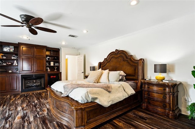 bedroom with crown molding, dark hardwood / wood-style floors, and ceiling fan