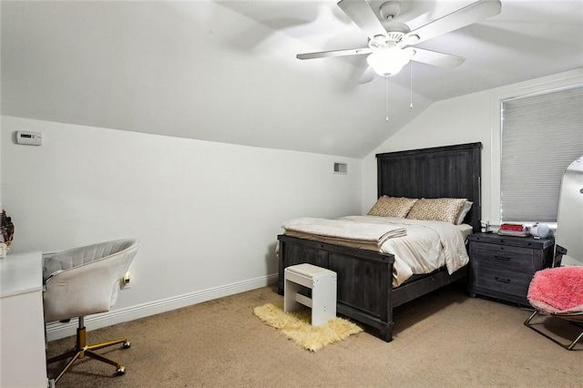 bedroom featuring ceiling fan, vaulted ceiling, and light carpet