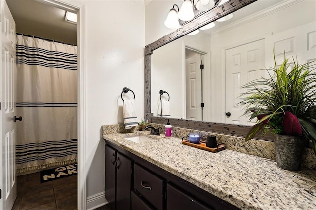 bathroom with vanity, ornamental molding, and tile patterned floors