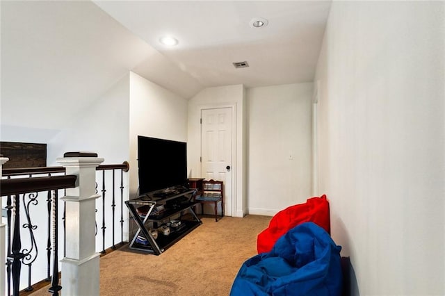 sitting room featuring vaulted ceiling and carpet floors