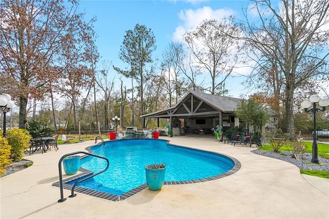 view of pool featuring an outbuilding and a patio