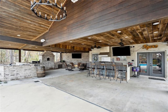 view of patio / terrace featuring a fireplace and a bar