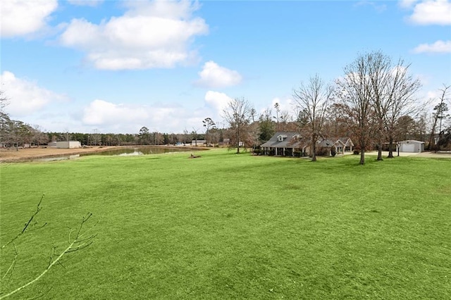 view of community featuring a yard and a water view