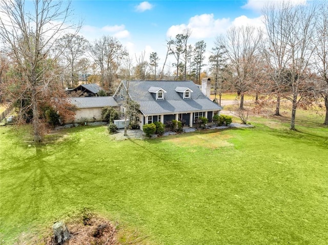 back of property featuring a yard and covered porch