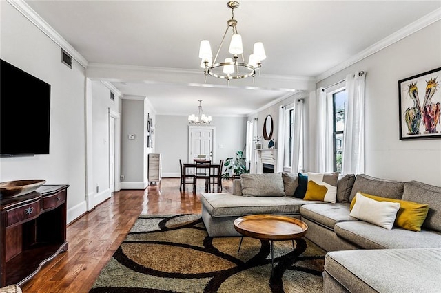 living room featuring ornamental molding, dark hardwood / wood-style floors, and a chandelier