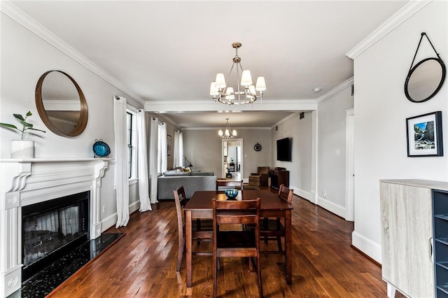 dining space with crown molding, a fireplace, dark hardwood / wood-style floors, and a chandelier