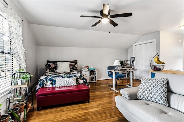 bedroom featuring wood-type flooring, vaulted ceiling, ceiling fan, and a closet