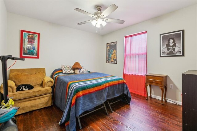 bedroom with ceiling fan and dark hardwood / wood-style flooring