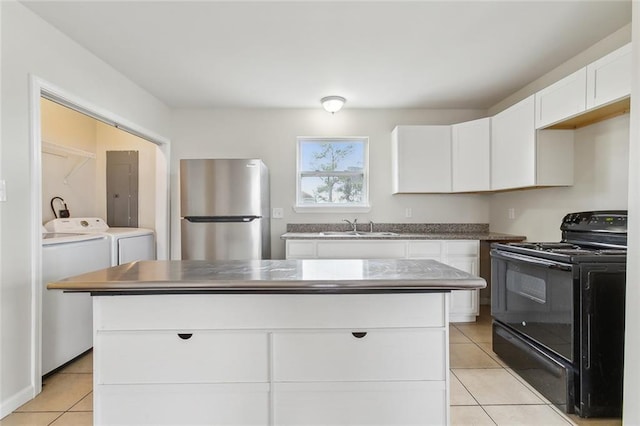 kitchen featuring a kitchen island, black electric range oven, sink, white cabinets, and stainless steel fridge