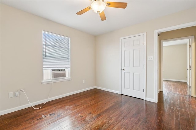 empty room with ceiling fan, cooling unit, and dark hardwood / wood-style flooring