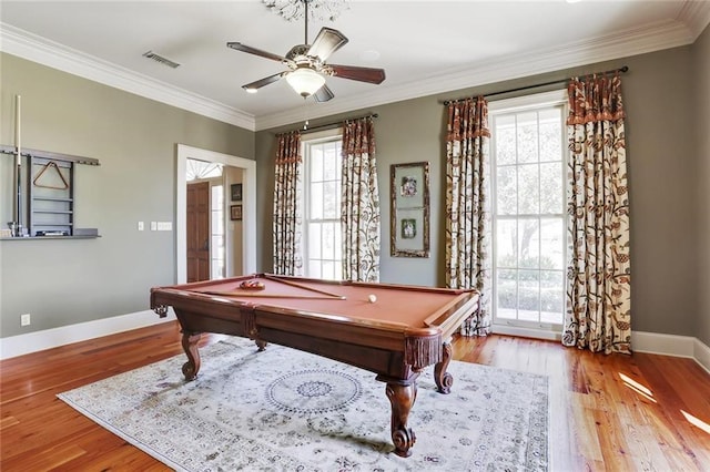 game room featuring ornamental molding, light hardwood / wood-style floors, and a healthy amount of sunlight