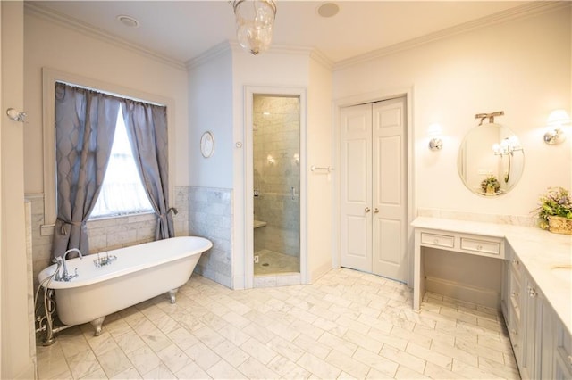 bathroom with vanity, ornamental molding, tile walls, and separate shower and tub