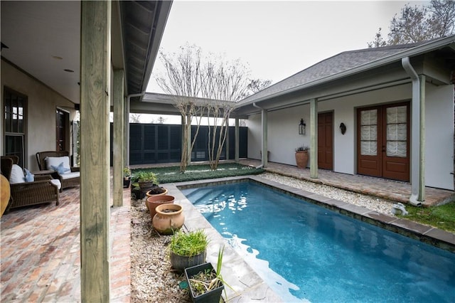 view of pool with an outdoor living space and a patio