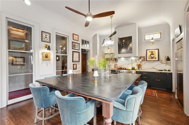 dining room with ceiling fan and dark hardwood / wood-style flooring