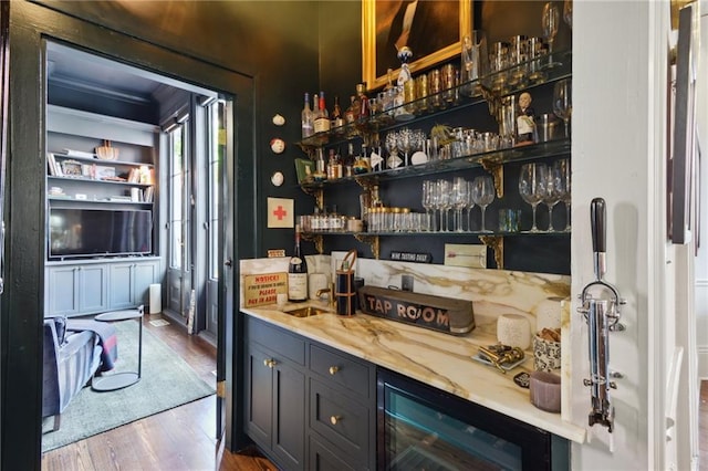 bar featuring hardwood / wood-style floors and beverage cooler