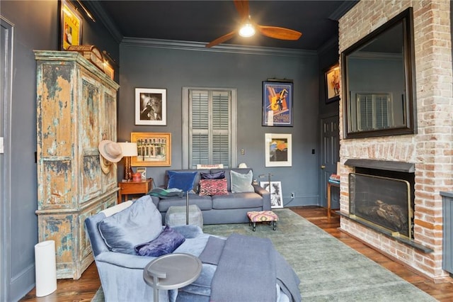 living room with crown molding, dark hardwood / wood-style flooring, and a fireplace