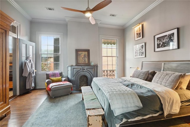 bedroom featuring multiple windows, ornamental molding, hardwood / wood-style flooring, and ceiling fan