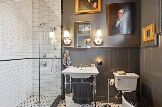 bathroom with toilet, an enclosed shower, and sink