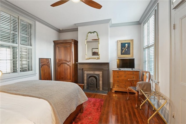 bedroom featuring crown molding, ceiling fan, and dark wood-type flooring