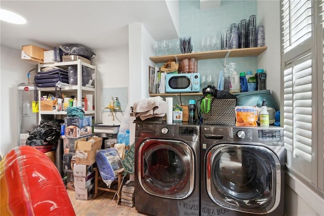 laundry room with electric water heater, wood-type flooring, and washer and dryer