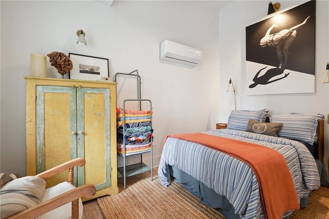 bedroom with hardwood / wood-style flooring and a wall unit AC