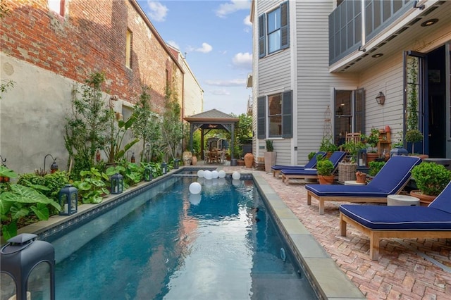 view of swimming pool featuring a gazebo and a patio area