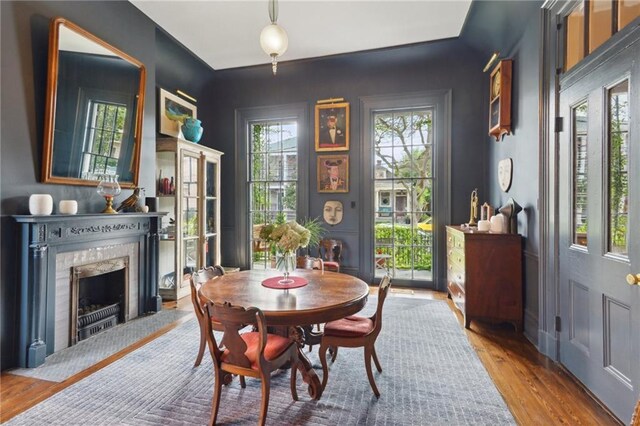 1013 Race St, New Orleans, LA 70130 - dining space with a high end fireplace, hardwood / wood-style floors, and plenty of natural light