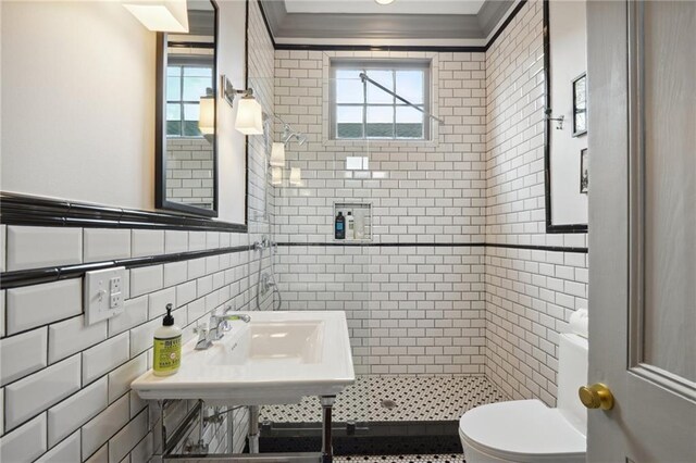 1013 Race St, New Orleans, LA 70130 - bathroom featuring a tile shower, sink, tile walls, toilet, and crown molding