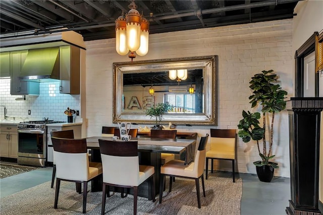 dining room with brick wall and concrete floors