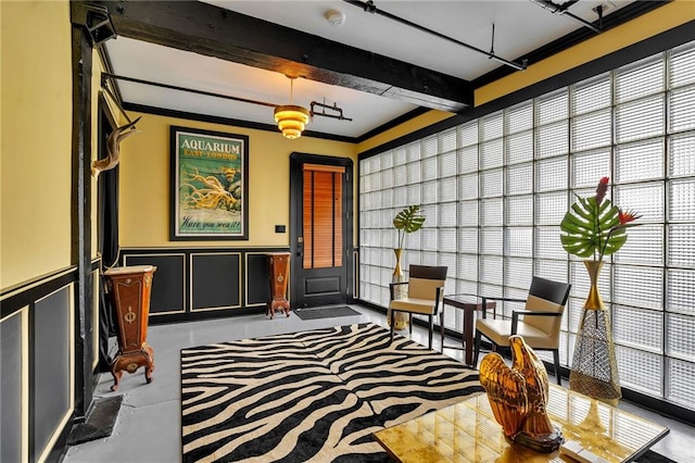 interior space with beamed ceiling and ornamental molding