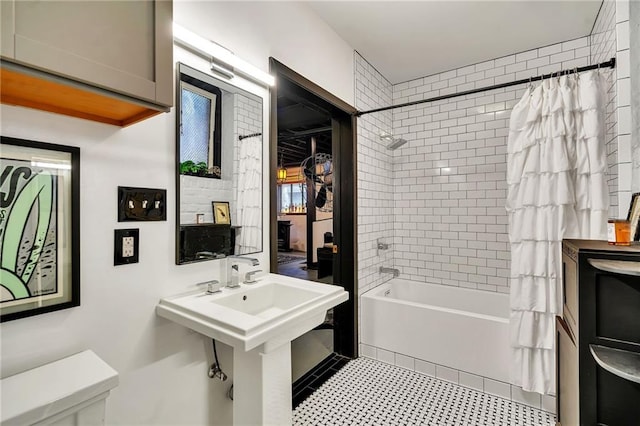 bathroom with toilet and shower / bath combo with shower curtain