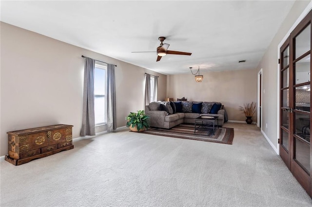 carpeted living room featuring ceiling fan