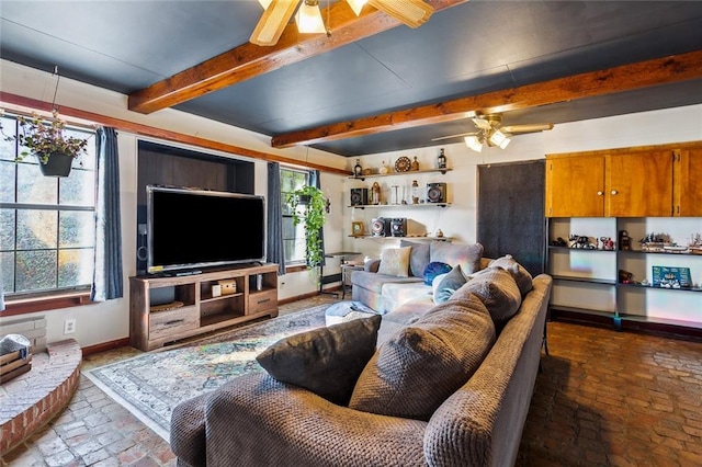 living room featuring beam ceiling and ceiling fan